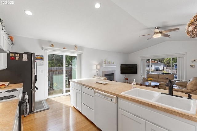 kitchen with range with electric cooktop, a sink, open floor plan, a wealth of natural light, and dishwasher