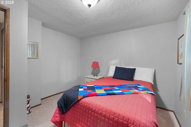 bedroom featuring light carpet and a textured ceiling