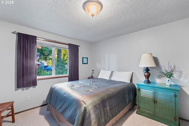 bedroom with light colored carpet and a textured ceiling