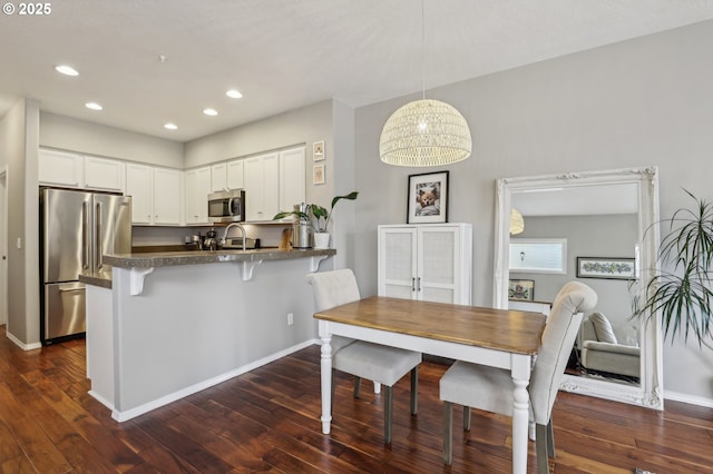 dining area featuring dark wood-type flooring, recessed lighting, and baseboards