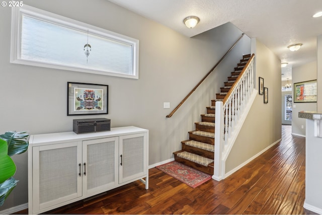 stairs featuring baseboards and hardwood / wood-style flooring