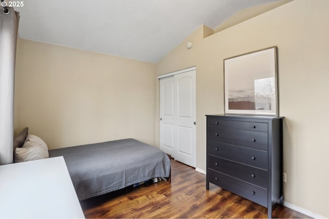 bedroom with baseboards, wood finished floors, and vaulted ceiling