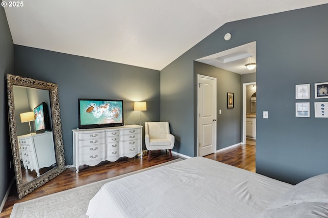 bedroom with baseboards, wood finished floors, and vaulted ceiling