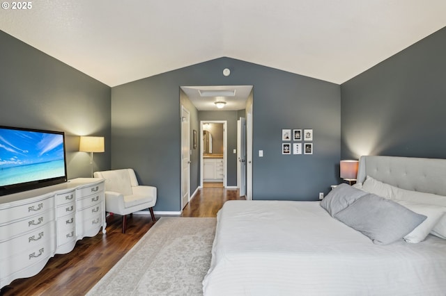 bedroom with vaulted ceiling, wood finished floors, and baseboards