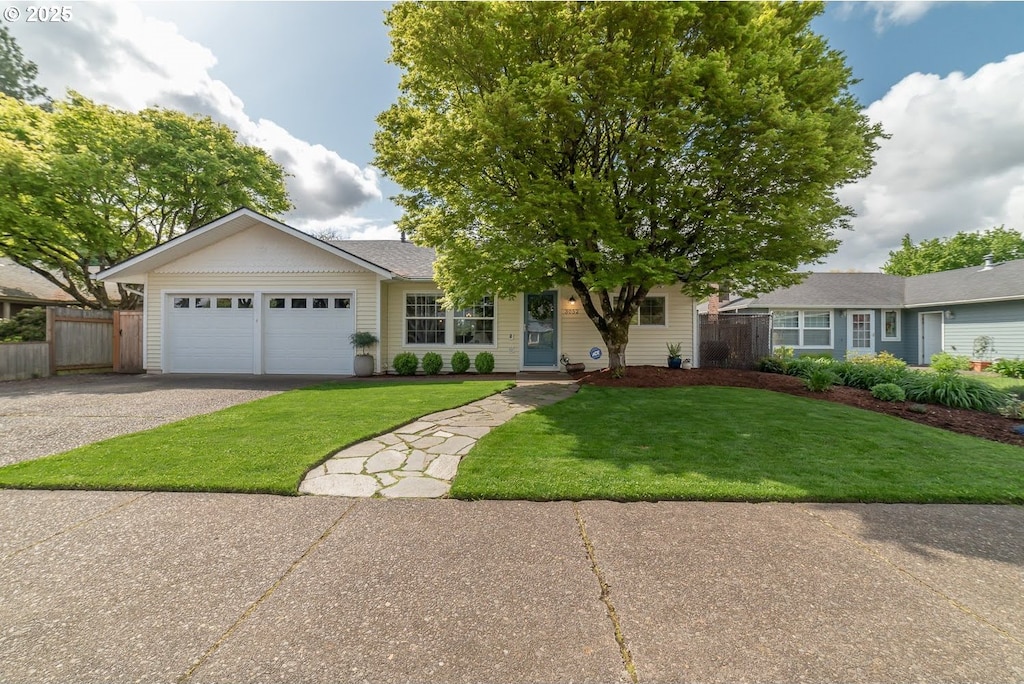 ranch-style house with a front yard and a garage