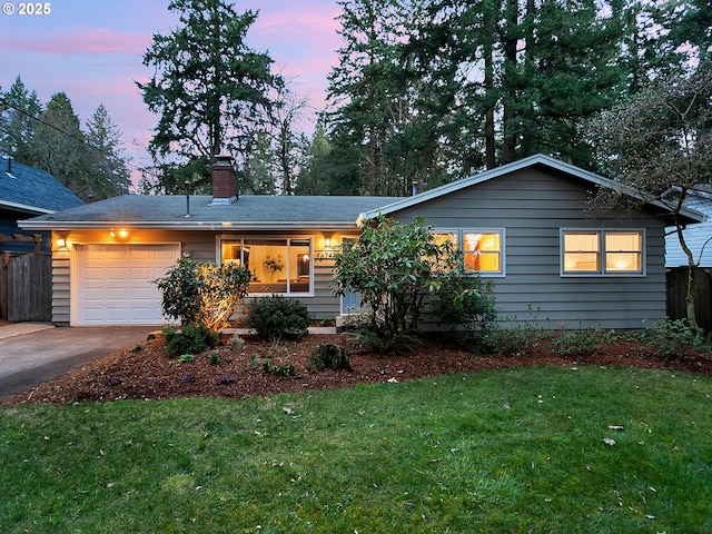 ranch-style home with driveway, fence, a yard, an attached garage, and a chimney