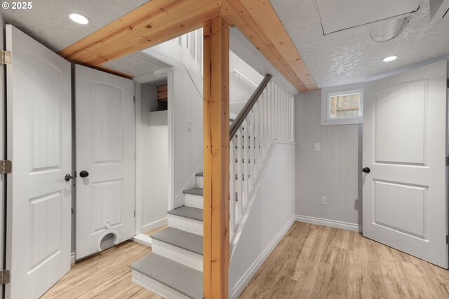 basement with a textured ceiling and light wood-type flooring