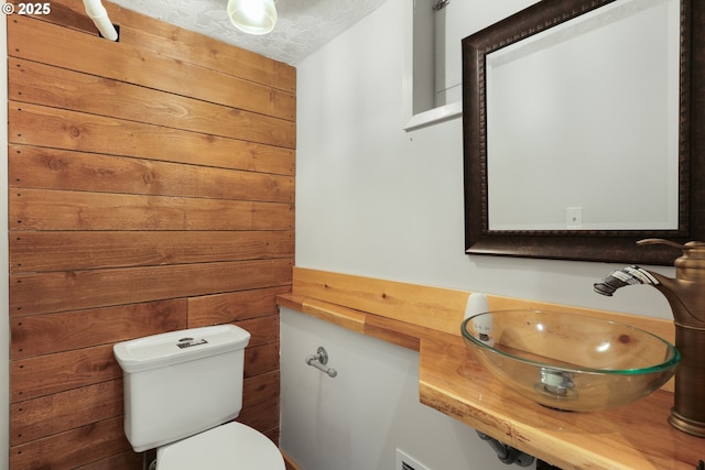 basement with light hardwood / wood-style floors and a textured ceiling