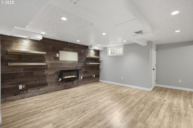 unfurnished living room with light wood-type flooring and ceiling fan