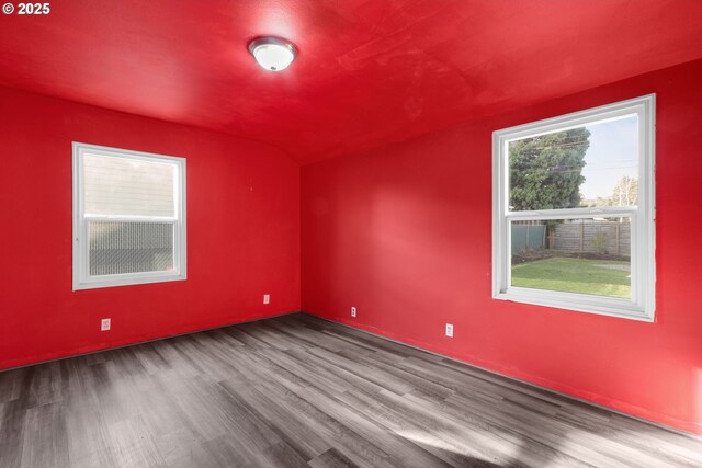 basement featuring a textured ceiling and light hardwood / wood-style flooring