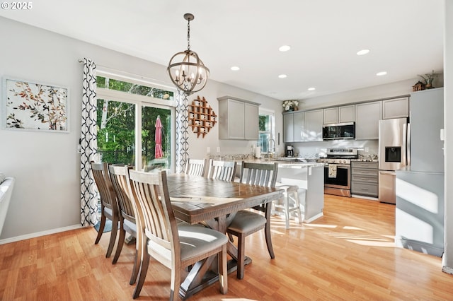 2149 SE Williams Dr, Gresham, OR 97080 - dining room featuring a chandelier, light wood finished floors, recessed lighting, and baseboards
