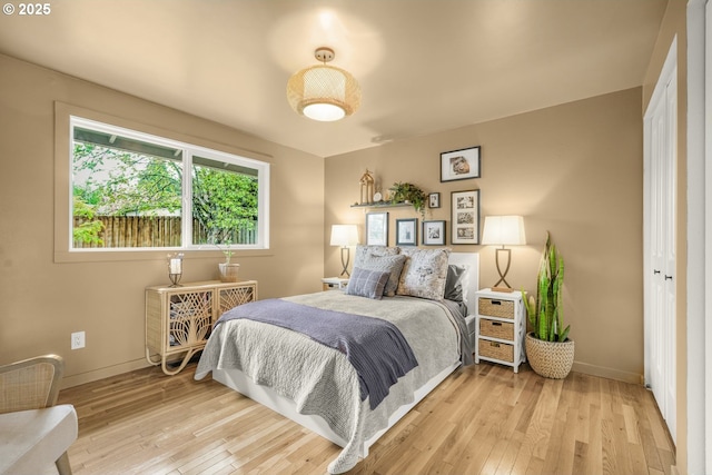 bedroom with baseboards and light wood-style flooring