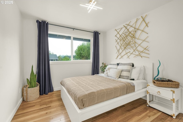 bedroom with baseboards and light wood-style flooring