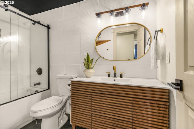 bathroom with vanity, toilet, tile walls, tasteful backsplash, and bath / shower combo with glass door