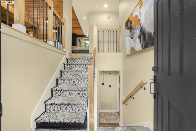 staircase featuring visible vents and recessed lighting