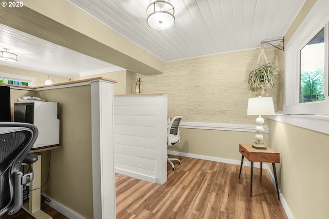 interior space with baseboards, wood ceiling, and wood finished floors