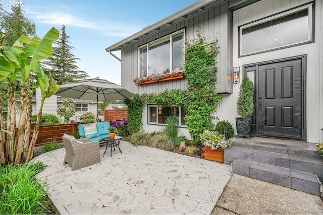 rear view of house featuring a patio, an outdoor living space, and fence