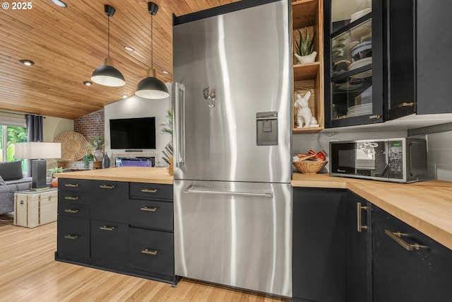 kitchen featuring stainless steel fridge, butcher block countertops, open floor plan, and wooden ceiling