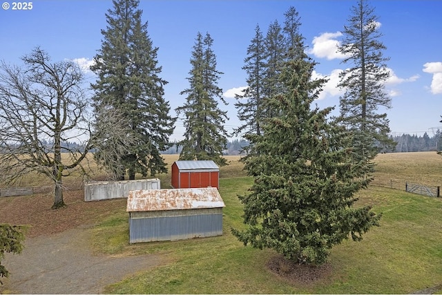 view of yard featuring a rural view and an outdoor structure