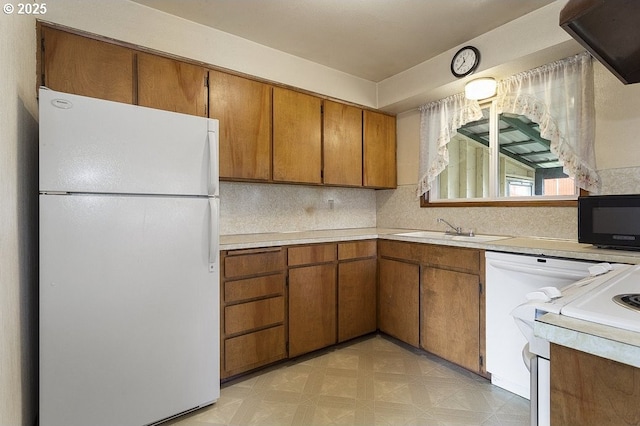 kitchen with white refrigerator, sink, and stove