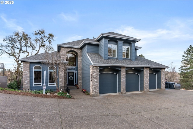 view of front facade with concrete driveway, brick siding, roof with shingles, and an attached garage