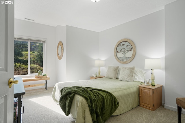 bedroom featuring light carpet, visible vents, and baseboards