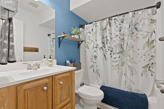 bathroom featuring toilet, vanity, shower / bath combination with curtain, and visible vents