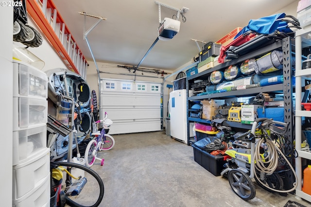 garage with a garage door opener and white fridge