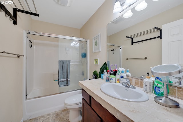 full bathroom with vanity, shower / bath combination with glass door, and toilet