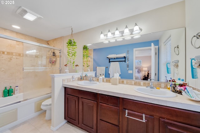 full bathroom with enclosed tub / shower combo, vanity, tile patterned floors, and toilet