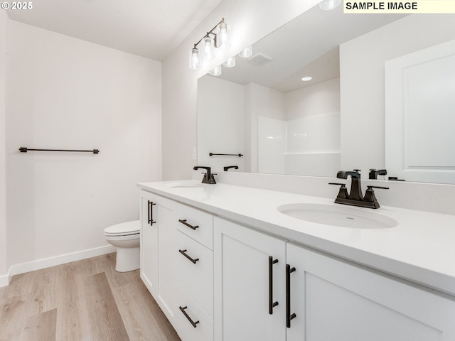 846 NW 178th Way, Ridgefield, WA 98642 - bathroom featuring double vanity, wood finished floors, and a shower