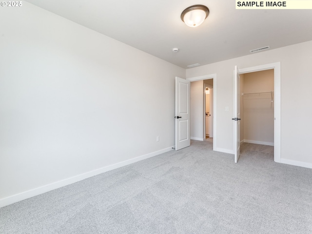 846 NW 178th Way, Ridgefield, WA 98642 - unfurnished bedroom featuring light colored carpet, a walk in closet, and a closet