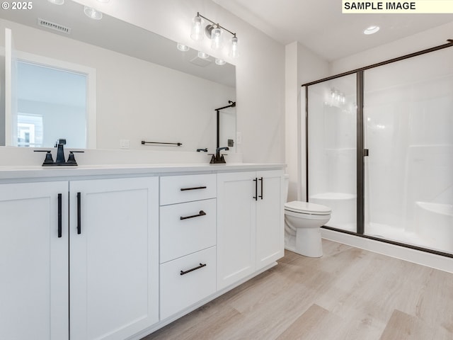846 NW 178th Way, Ridgefield, WA 98642 - bathroom featuring wood finished floors, double vanity, and a stall shower