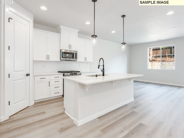846 NW 178th Way, Ridgefield, WA 98642 - kitchen featuring stainless steel microwave, decorative backsplash, light wood-style flooring, light countertops, and recessed lighting