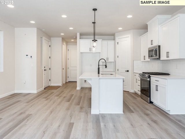846 NW 178th Way, Ridgefield, WA 98642 - kitchen with appliances with stainless steel finishes, recessed lighting, backsplash, light wood-style floors, and light countertops