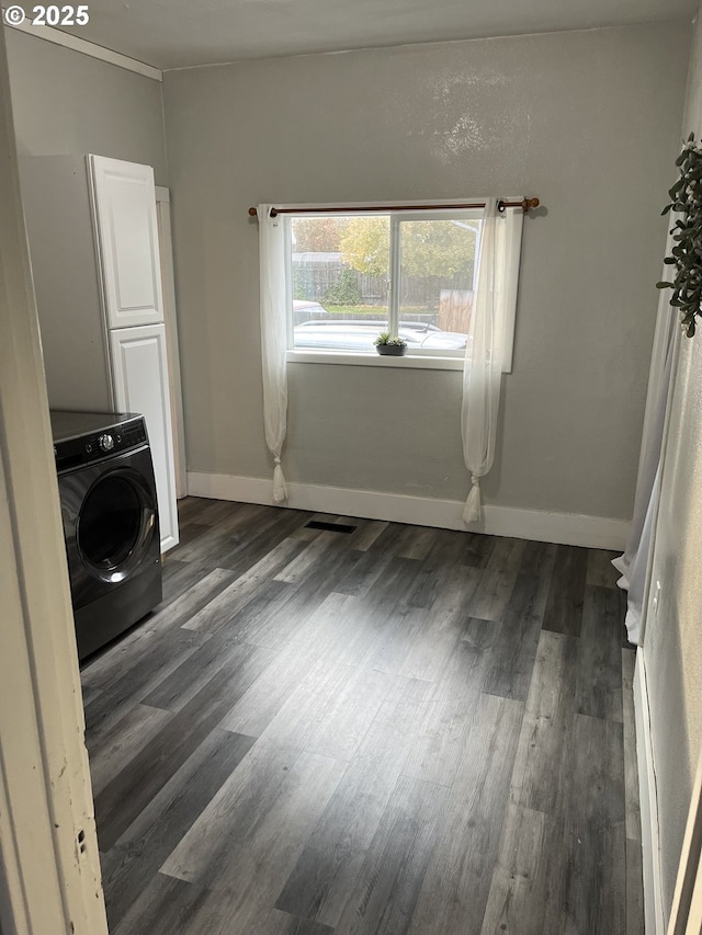 interior space with dark wood-type flooring and washer / clothes dryer