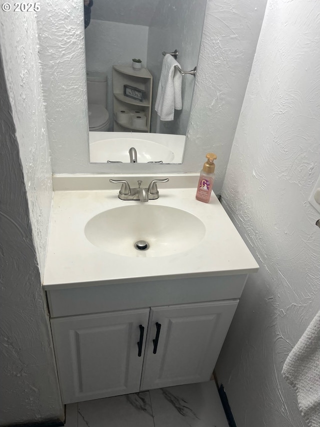 bathroom with vanity and toilet