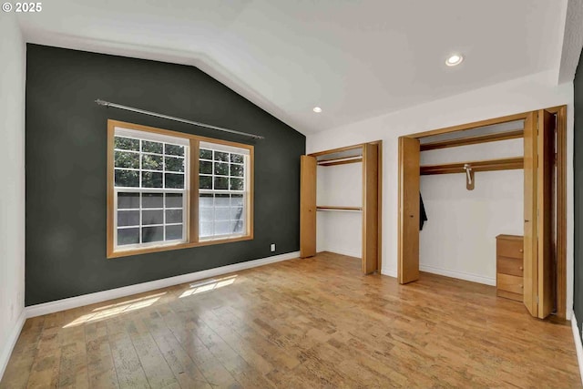 668 River Rd, Eugene, OR 97404 - unfurnished bedroom with multiple closets, wood finished floors, lofted ceiling, and recessed lighting