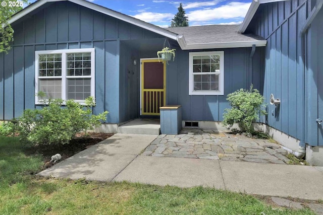 668 River Rd, Eugene, OR 97404 - property entrance with board and batten siding and a shingled roof