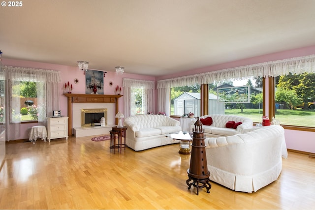 1218 SE Single Tree Dr, Vancouver, WA 98683 - living area featuring a fireplace with raised hearth, plenty of natural light, and wood finished floors