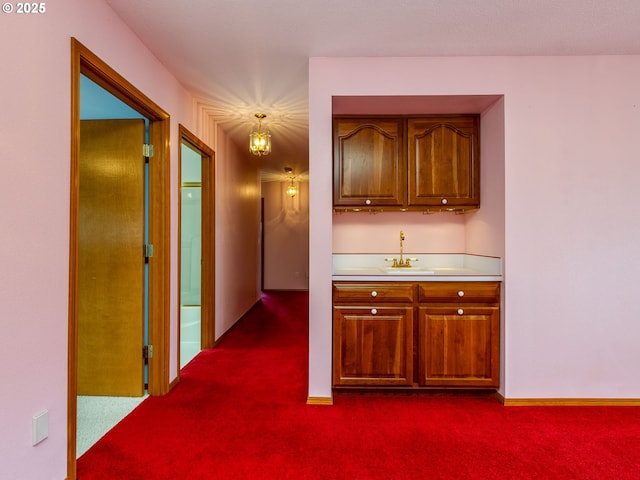 1218 SE Single Tree Dr, Vancouver, WA 98683 - kitchen with dark carpet, light countertops, and brown cabinetry