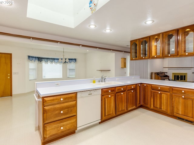 1218 SE Single Tree Dr, Vancouver, WA 98683 - kitchen with dishwasher, brown cabinetry, light countertops, recessed lighting, and glass insert cabinets