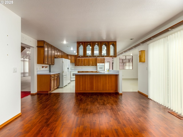 1218 SE Single Tree Dr, Vancouver, WA 98683 - kitchen featuring freestanding refrigerator, brown cabinetry, range, and a peninsula