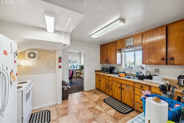 kitchen featuring white appliances and sink