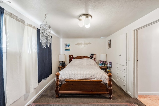 carpeted bedroom featuring a textured ceiling