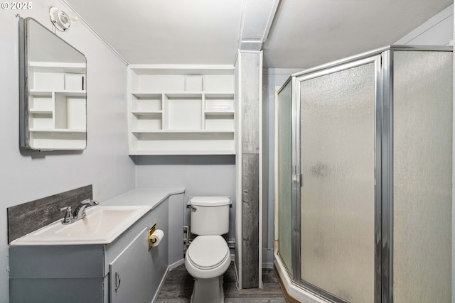 bathroom with vanity, wood-type flooring, toilet, and a shower with shower door