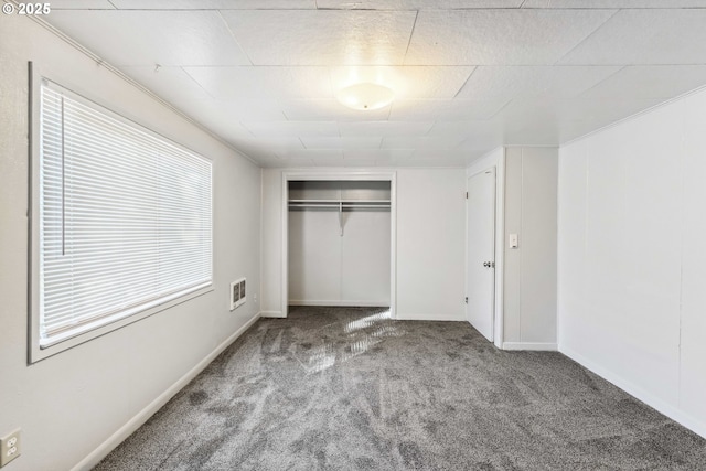 unfurnished bedroom with light carpet and a closet