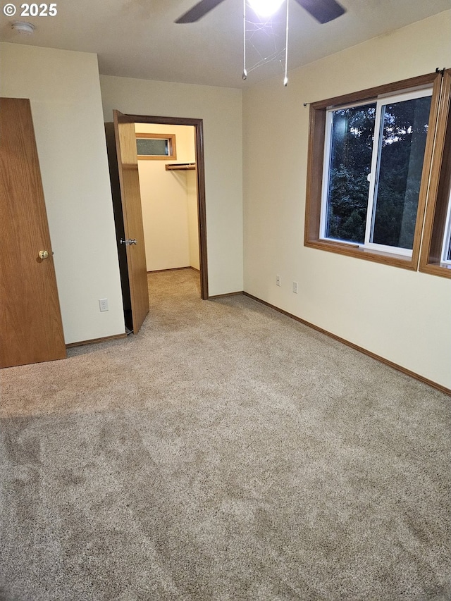 617 SW Monroe St, Sheridan, OR 97378 - unfurnished bedroom with light colored carpet, a walk in closet, a ceiling fan, and a closet
