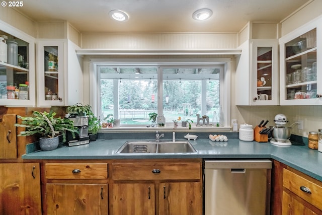 11885 Riverhaven Ln SE, Stayton, OR 97383 - kitchen with stainless steel dishwasher, a sink, brown cabinetry, glass insert cabinets, and white cabinetry