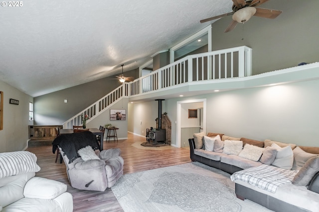 11885 Riverhaven Ln SE, Stayton, OR 97383 - living room featuring a ceiling fan, stairs, high vaulted ceiling, wood finished floors, and a wood stove